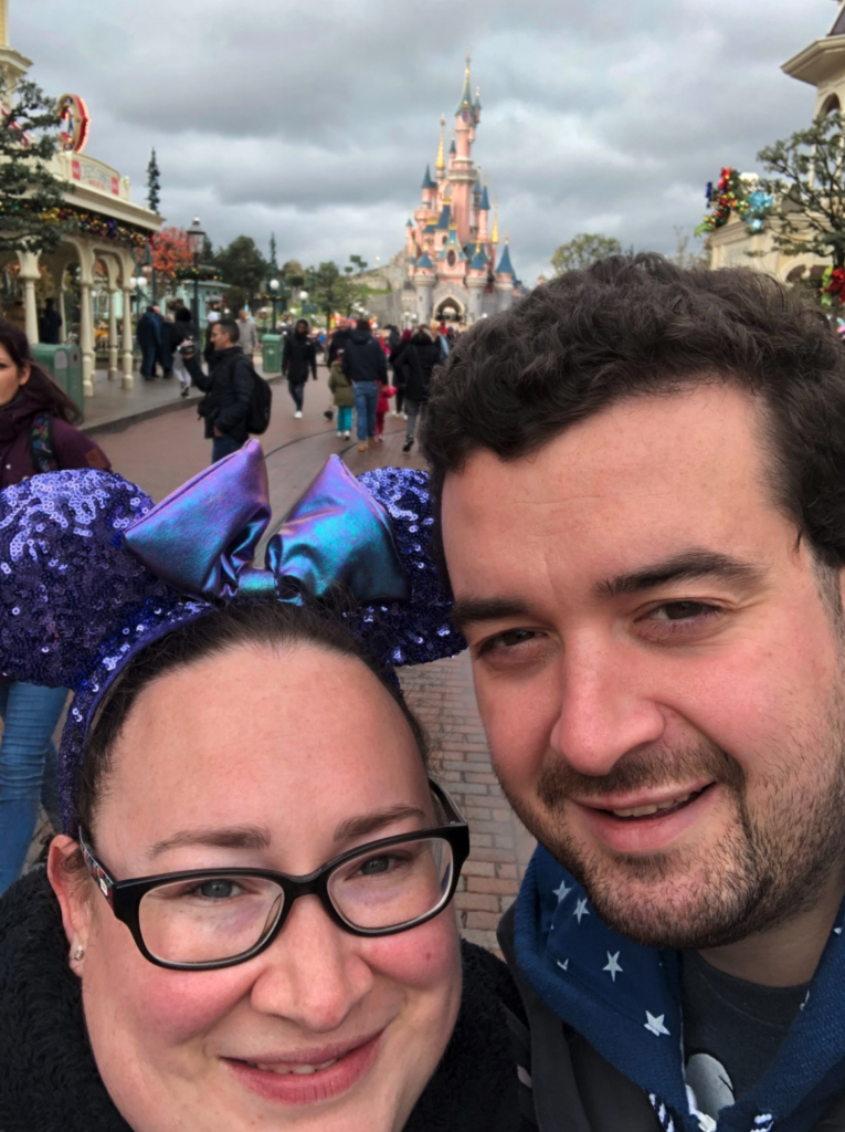 2 people in front of the Disney castle