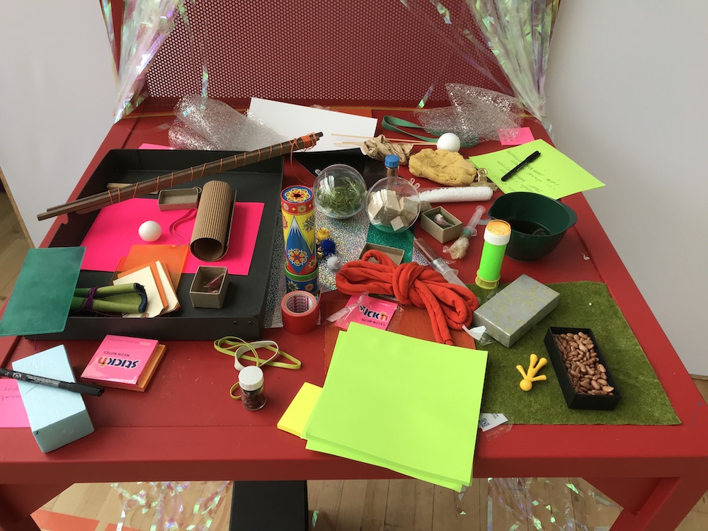 photo of craft table with paper, scissors, play-doh etc